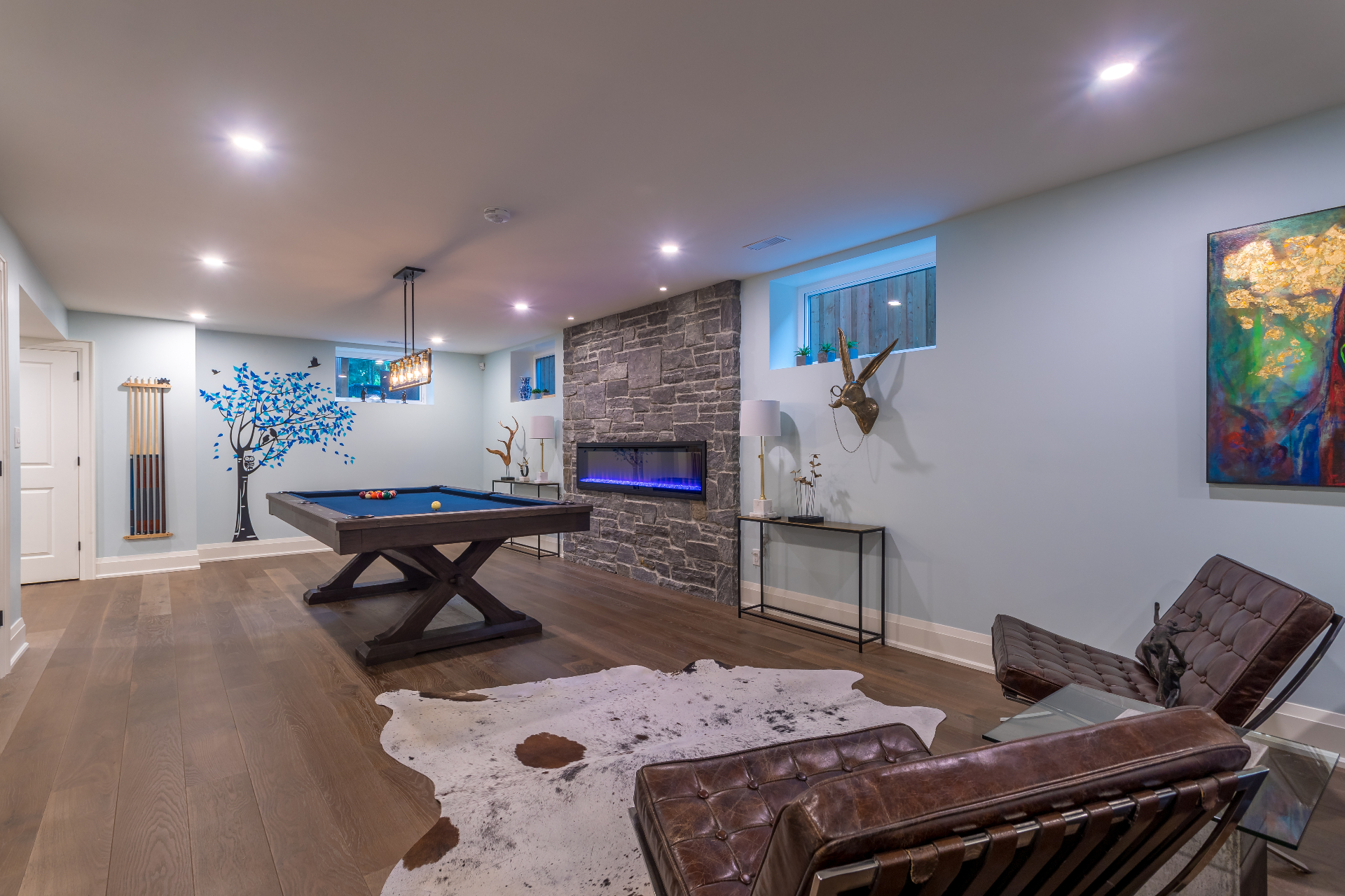 Finished basement recreation room with stone fireplace