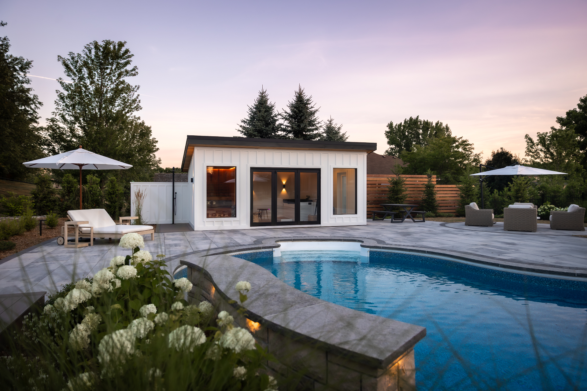 Wellness cabana with sauna and cold plunge near a pool