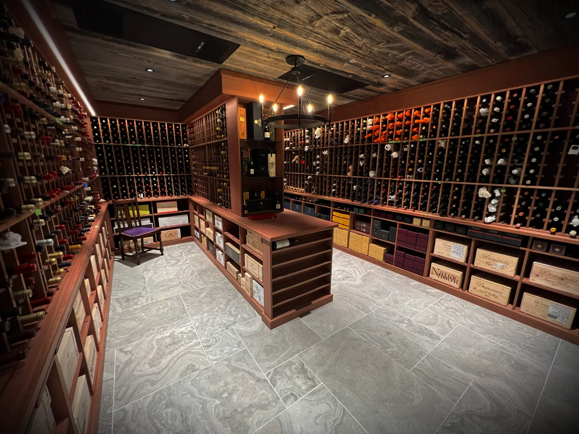 Custom wine cellar with hardwood racking and barnboard ceiling