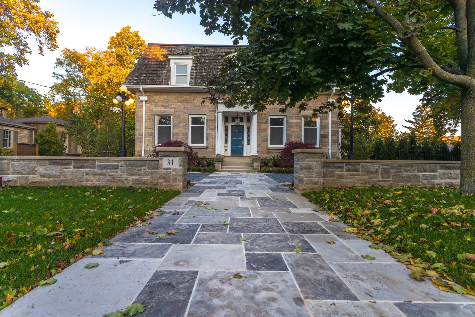 Wide flagstone front walk with natural stone walls