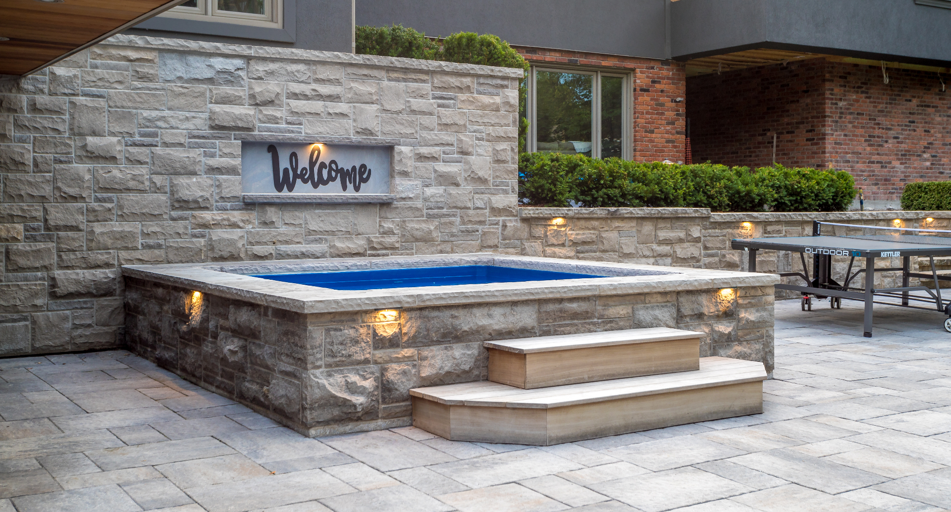 Stone-clad integrated hot tub