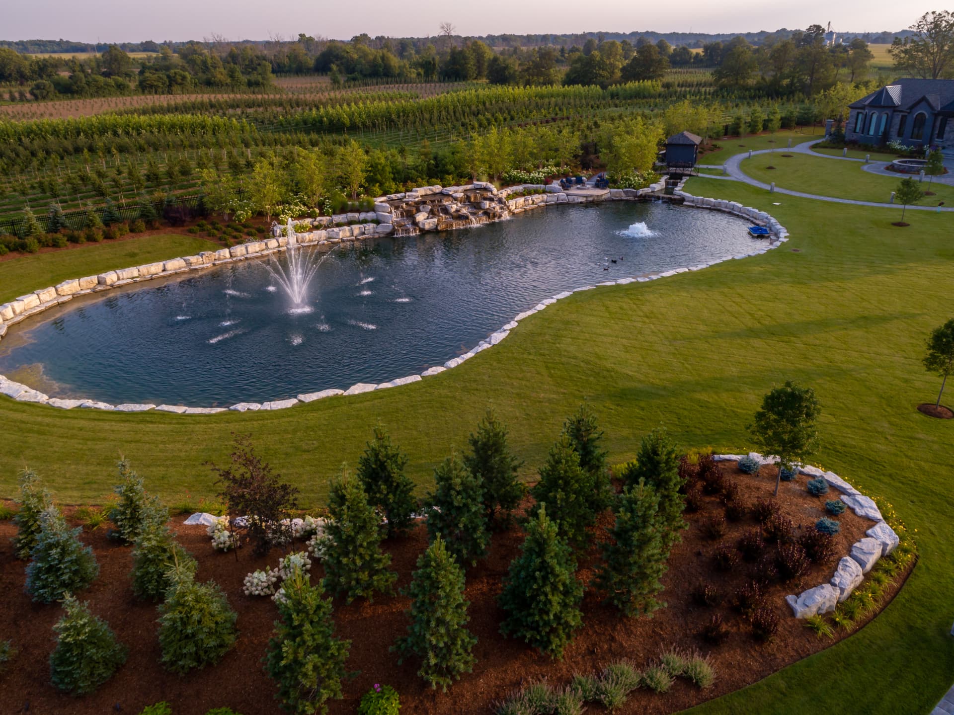 Spring-fed pond with a stone waterfall beside the vineyard