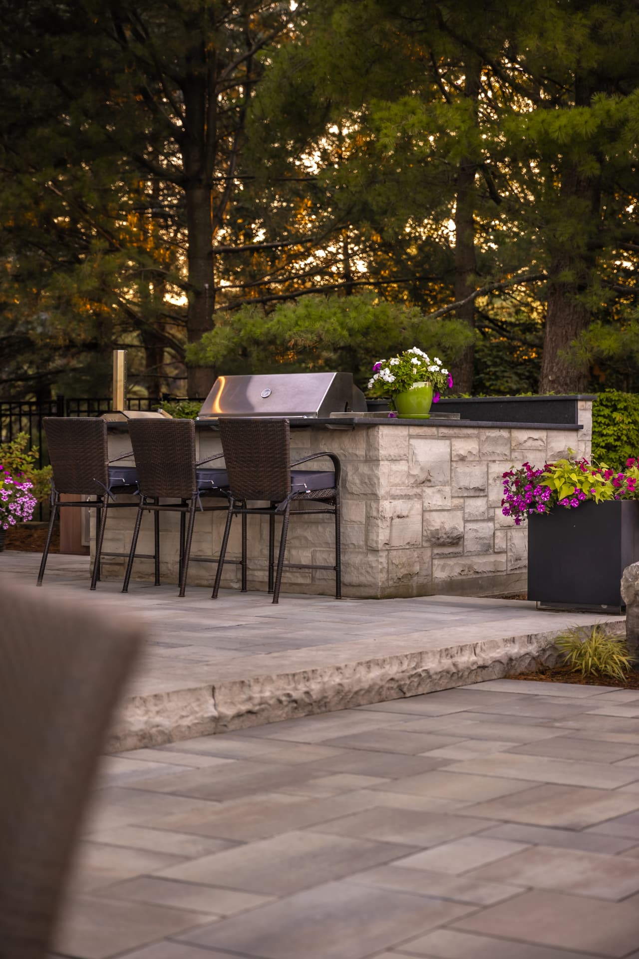 Stone-clad grill island with bar seating