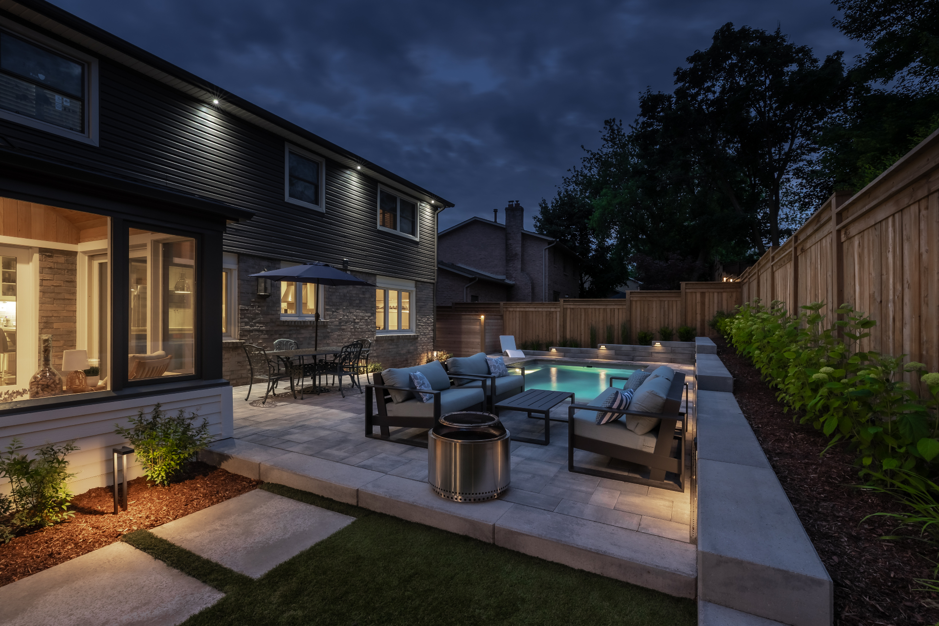The Luxe Escape — Firepit lounge beside the pool