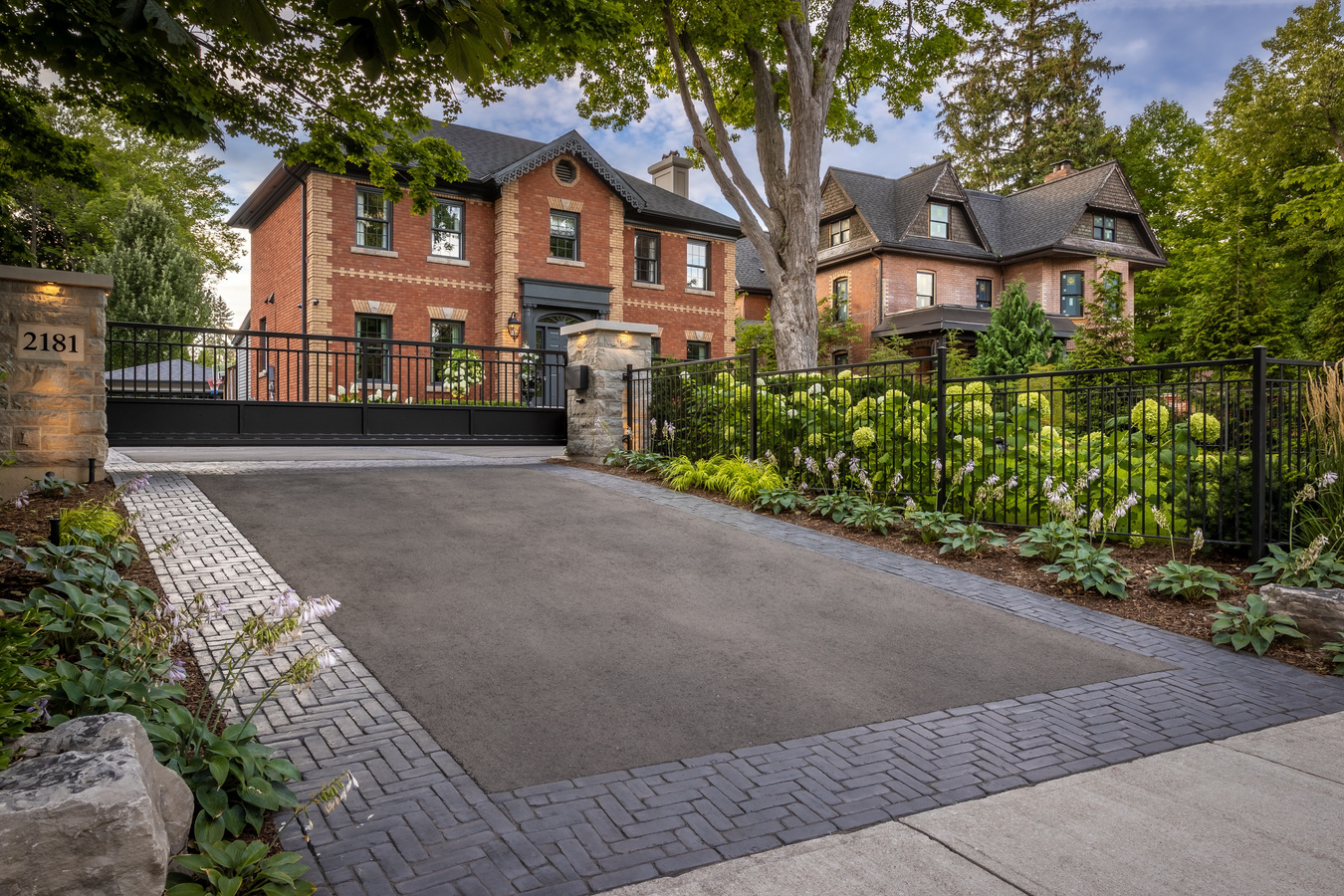 Asphalt driveway with cobblestone paver border