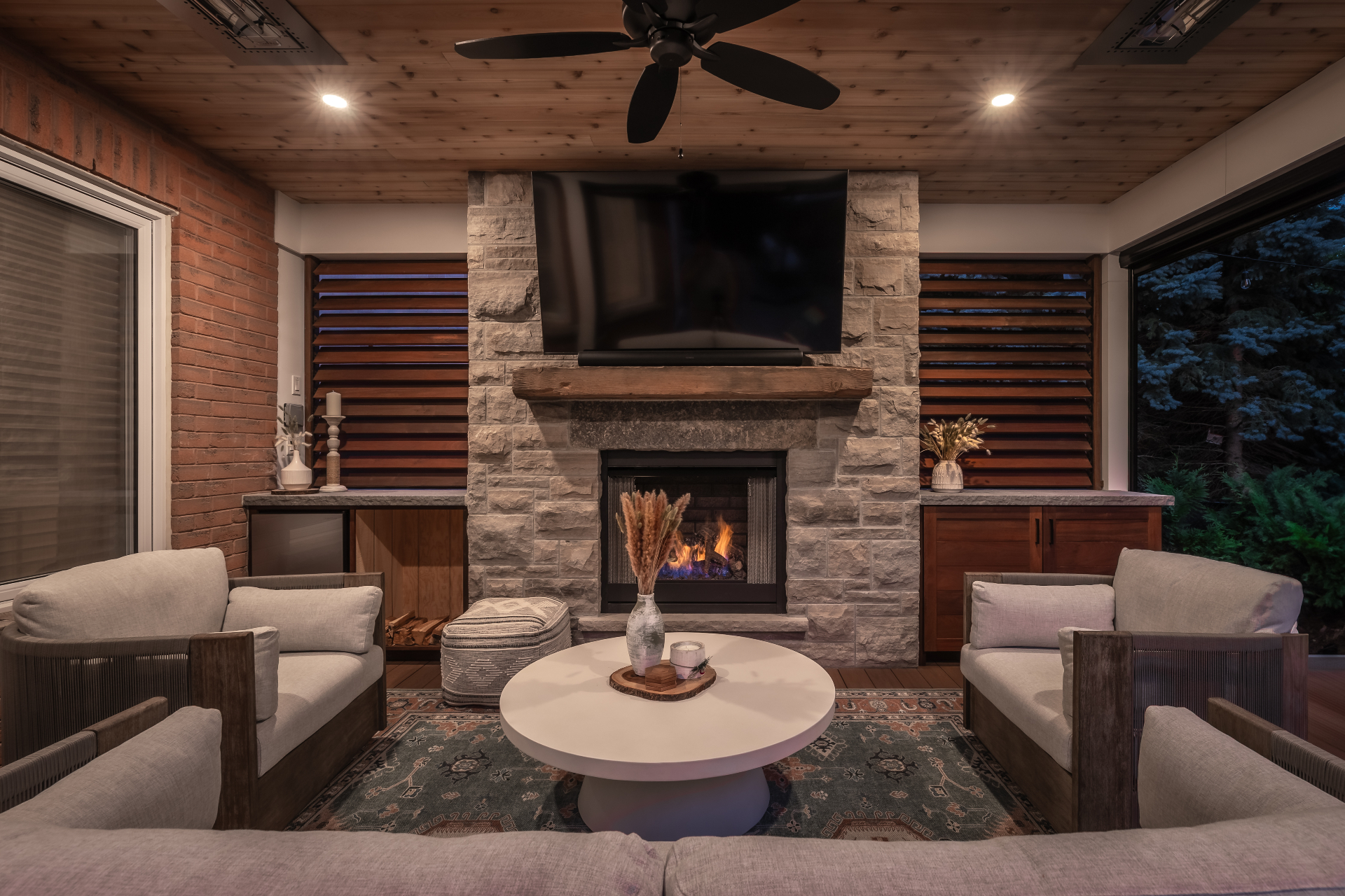 Stone hearth fireplace under a cedar-clad ceiling