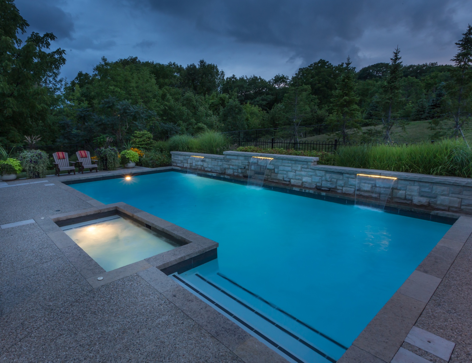 Integrated spa and pool with stone water features