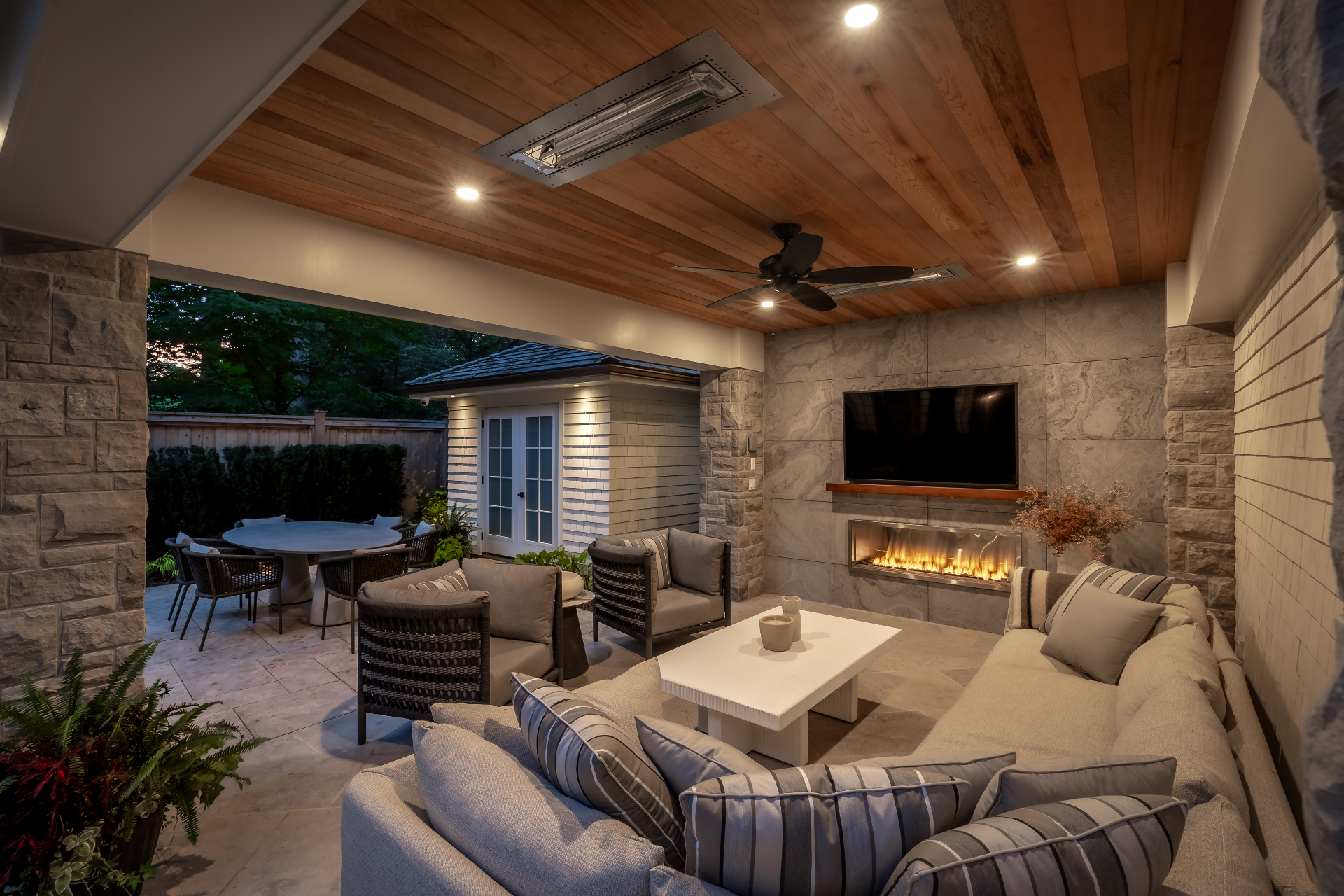 Covered patio lounge with linear gas fireplace