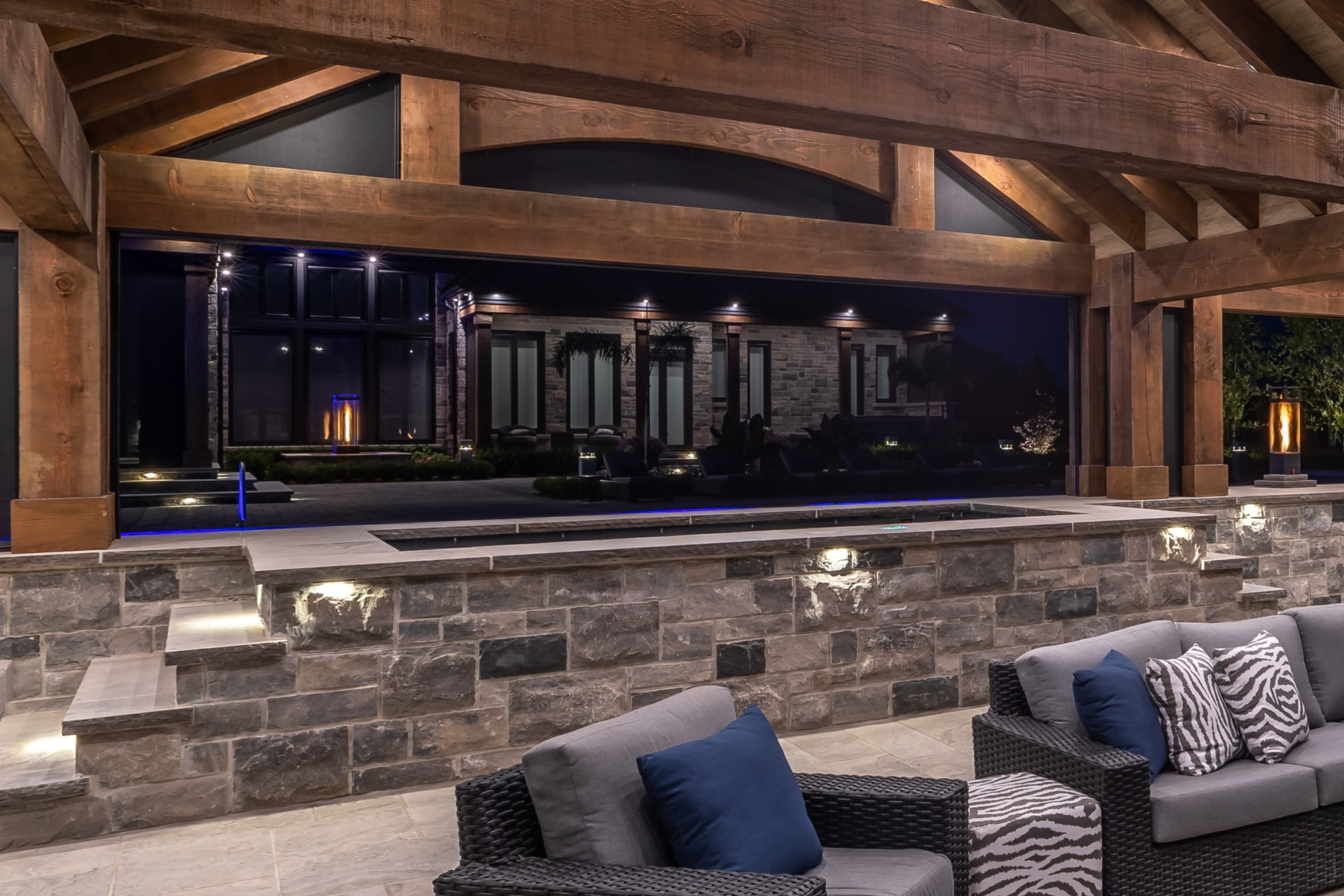 Spa and timber pavilion lounge with stone wall lighting