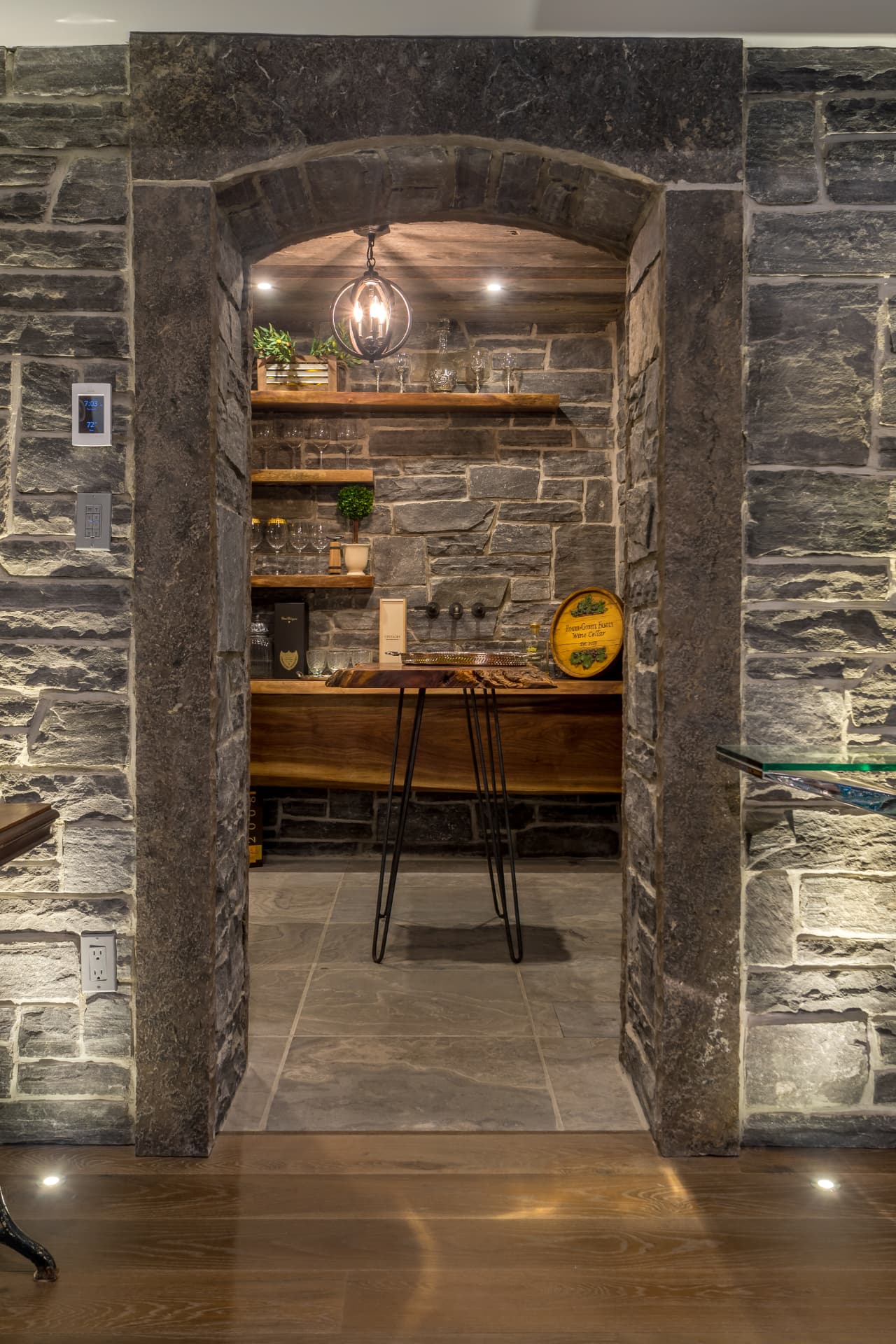 Stone wine cellar with reclaimed timber shelving and live-edge tasting table