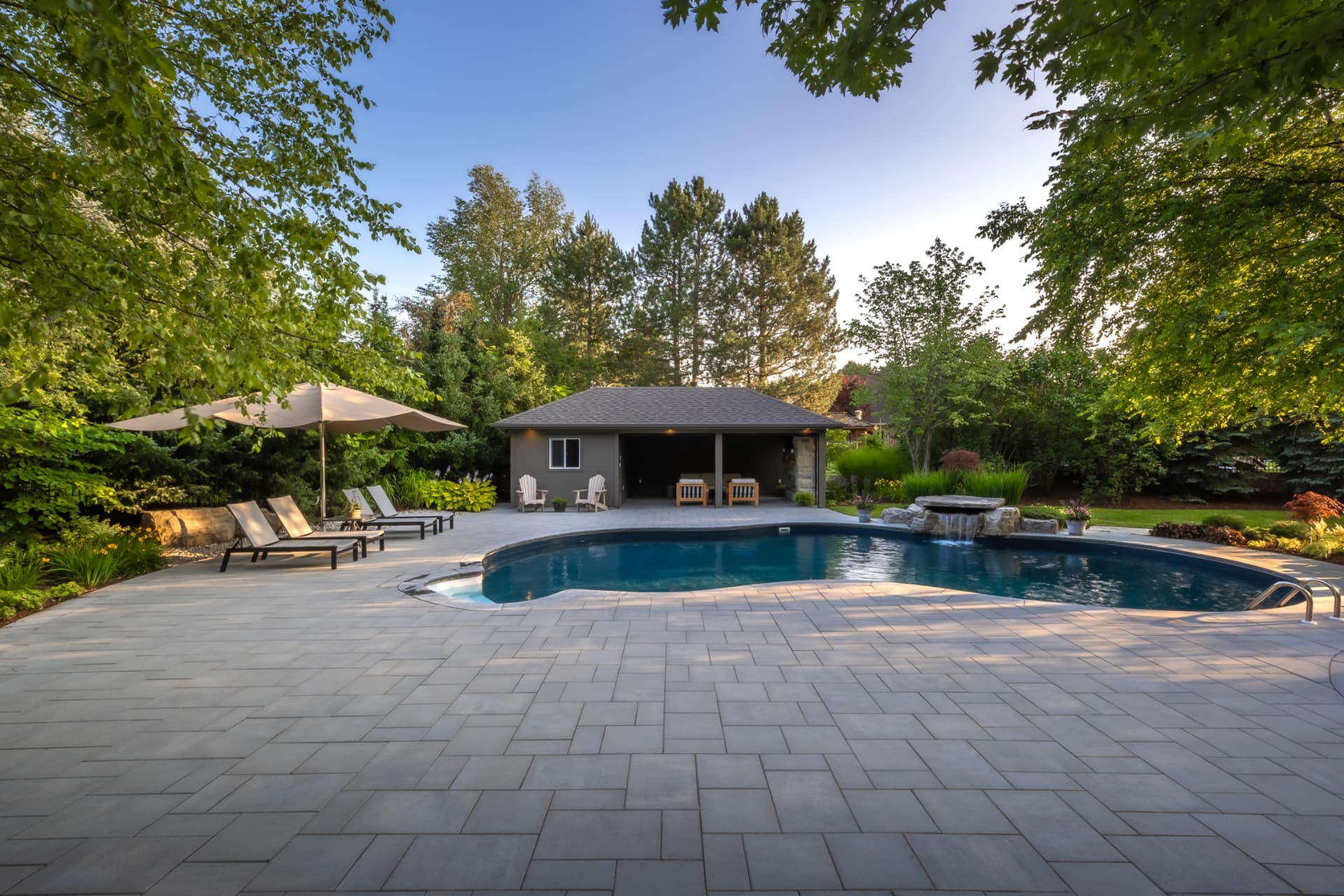 Paver pool patio leading to the pool house
